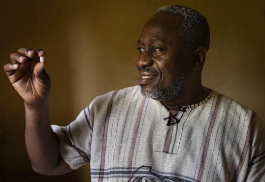 Dr Wilfried Mutombo, the Head of Clinical Operations for DNDi in the DRC, with acoziborole pill at the Dubreka Clinical Trial site in Dubreka.