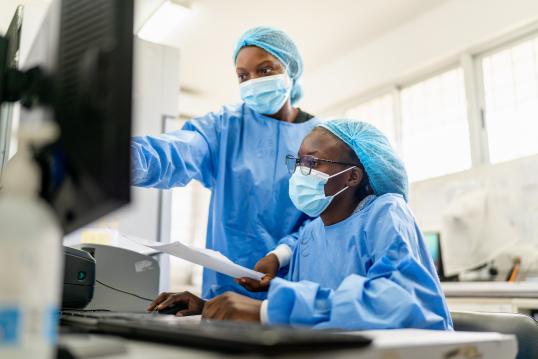 Researchers check results on the screen in Mozambique