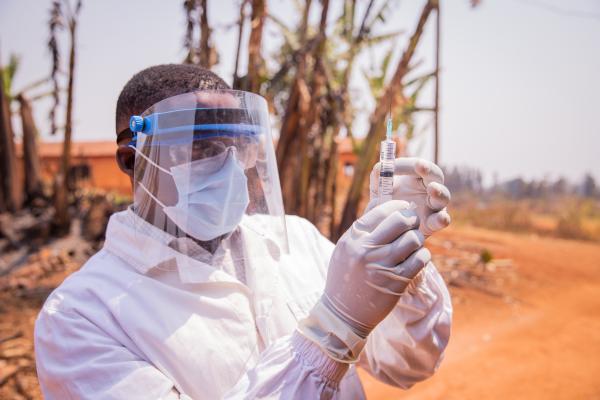 Doctor checks a vaccine syringe