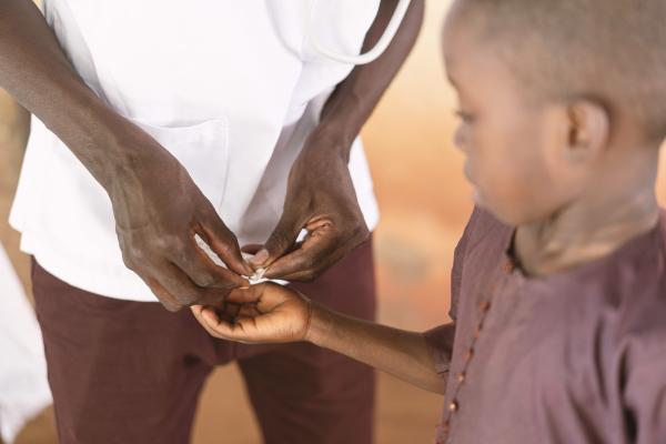 Doctor gives pills to child