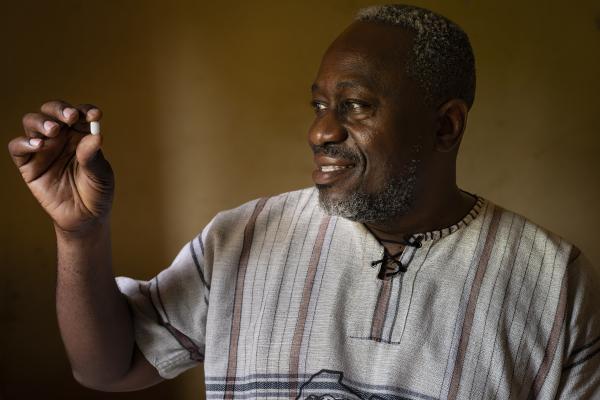 Dr Wilfried Mutombo, the Head of Clinical Operations for DNDi in the DRC, with acoziborole pill at the Dubreka Clinical Trial site in Dubreka.