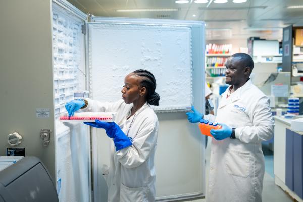 Scientists placing samples in the fridge 